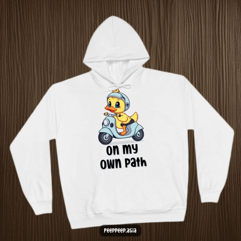 Funny hoodie featuring a playful duckling steering a scooter with a resolute expression, ready to conquer.