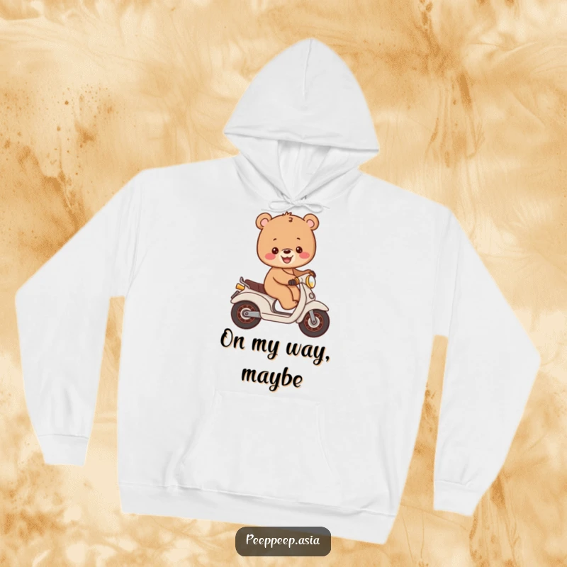 Funny cheerful brown bear cub balancing on a small moped, printed on a plush hoodie for warm, humorous comfort.